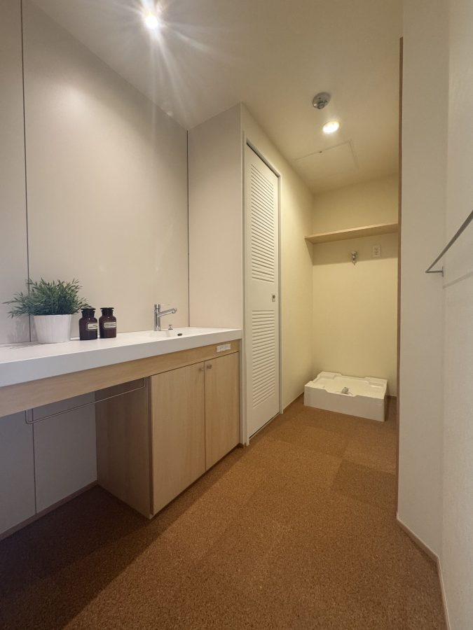 以前は洗濯機パンの場所に洗面台がありましたが、ユニットバスを広くしたことで、洗面台を入口側にレイアウト変更。帰宅後すぐに手を洗える、快適な動線になりました。